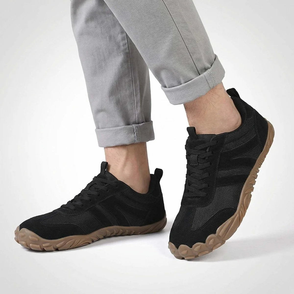 Black walking trainers shown on foot