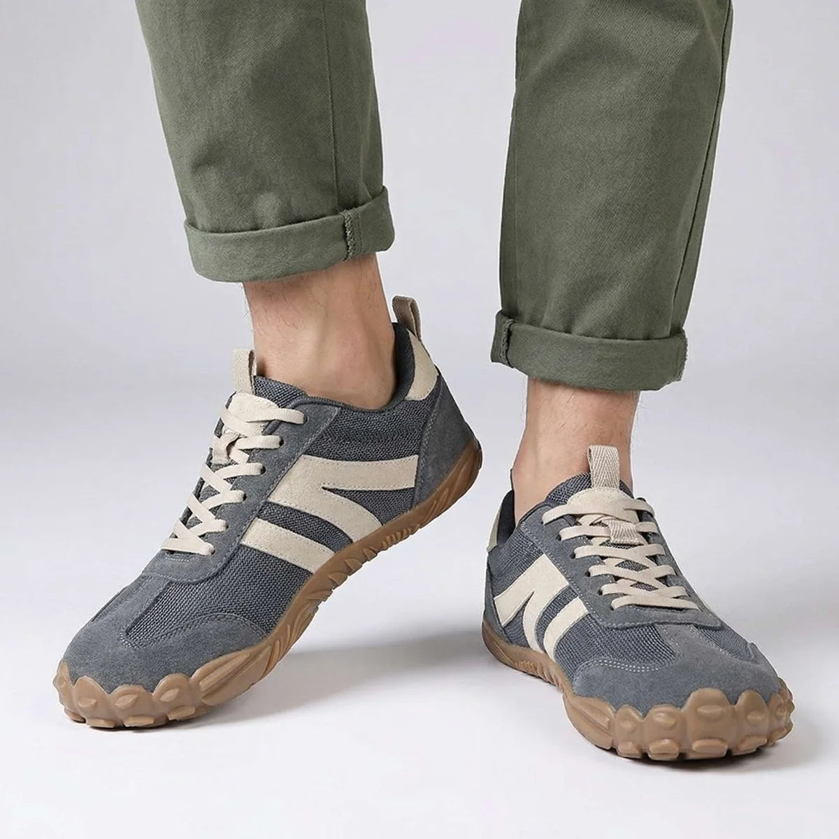 Grey walking trainers shown on foot