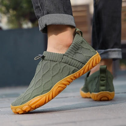 Dark green barefoot walking shoes worn outdoors, side view