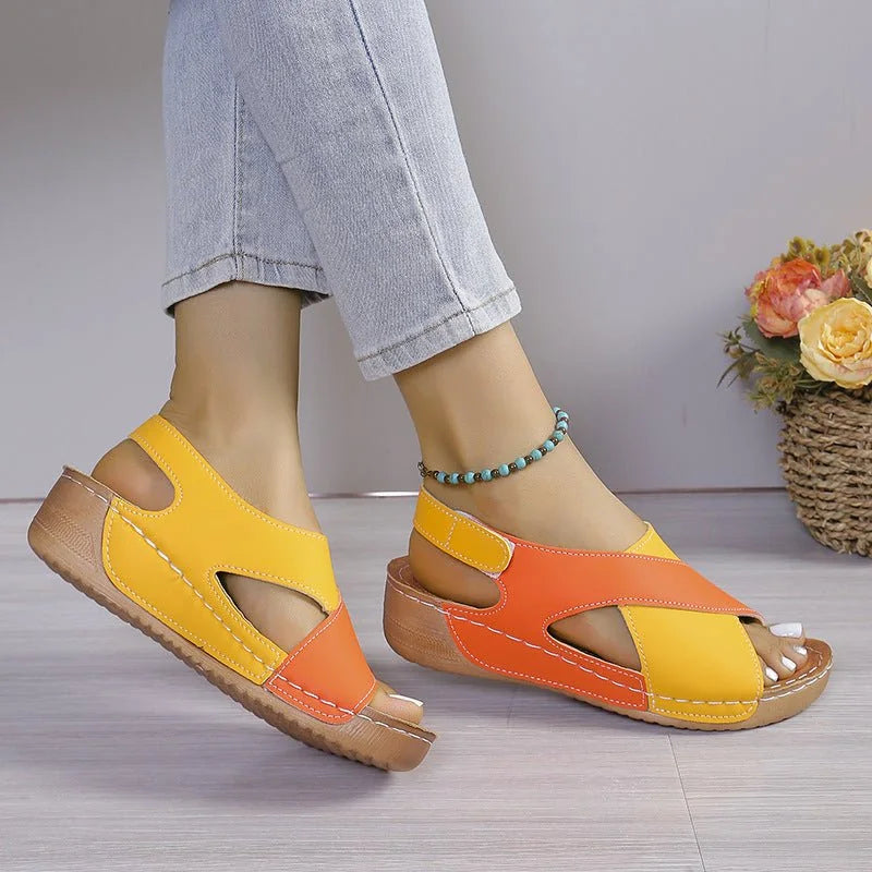 Orange and yellow criss-cross sandals, rear side on-foot view