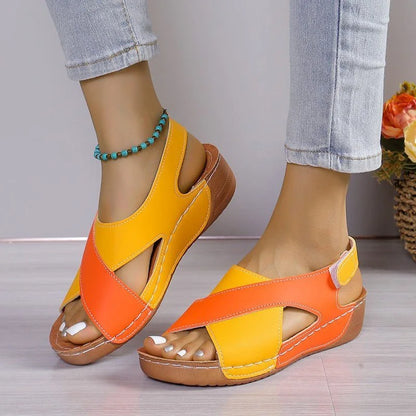 Orange and yellow criss-cross walking sandals, front on-foot view