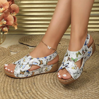 Butterfly pattern walking sandals worn indoors, side view