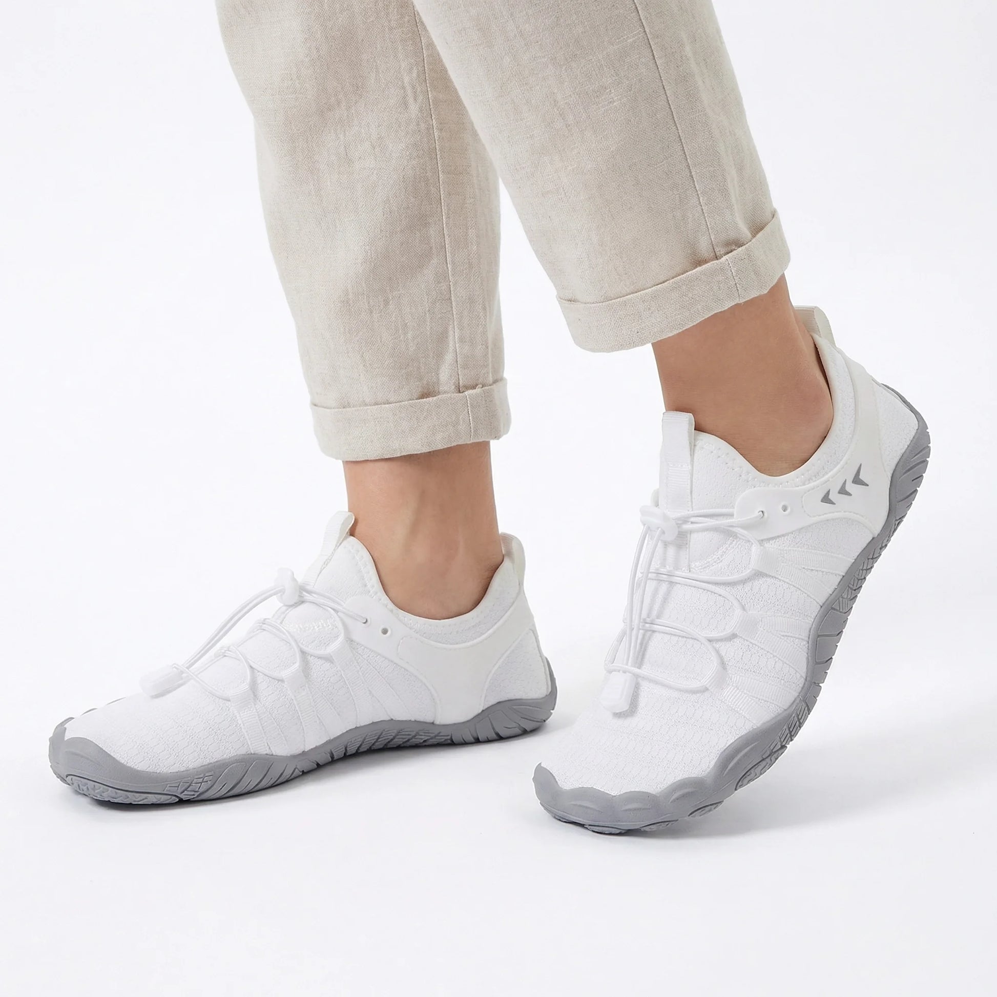 Crisp white wide toe box shoes worn with light trousers, side view
