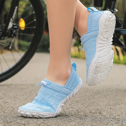 Blue barefoot-style shoe worn on foot with outsole view