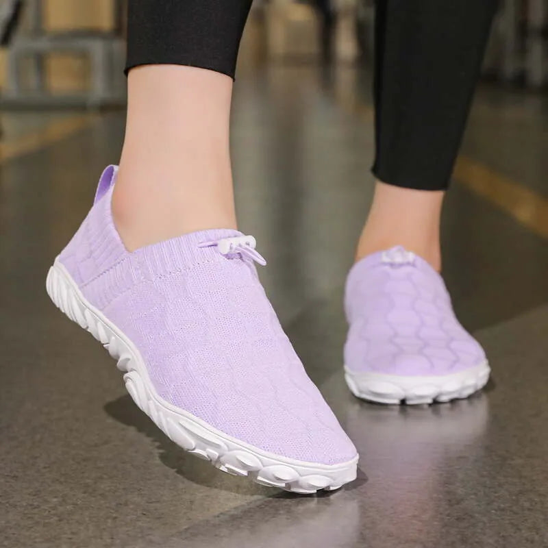 Purple barefoot walking shoes worn indoors, front view