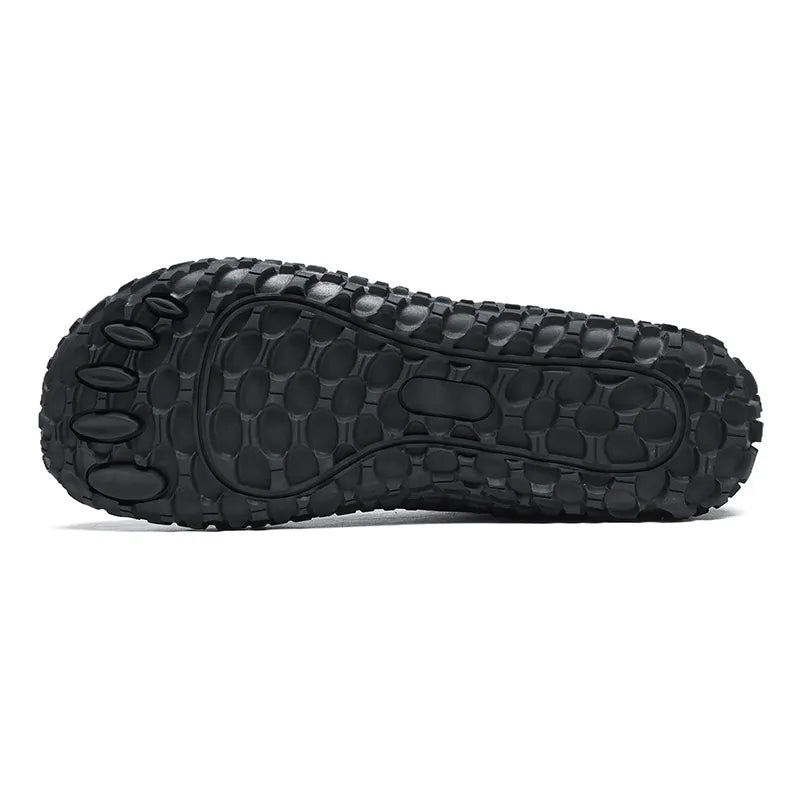 Textured black outsole of a wide toe walking trainer
