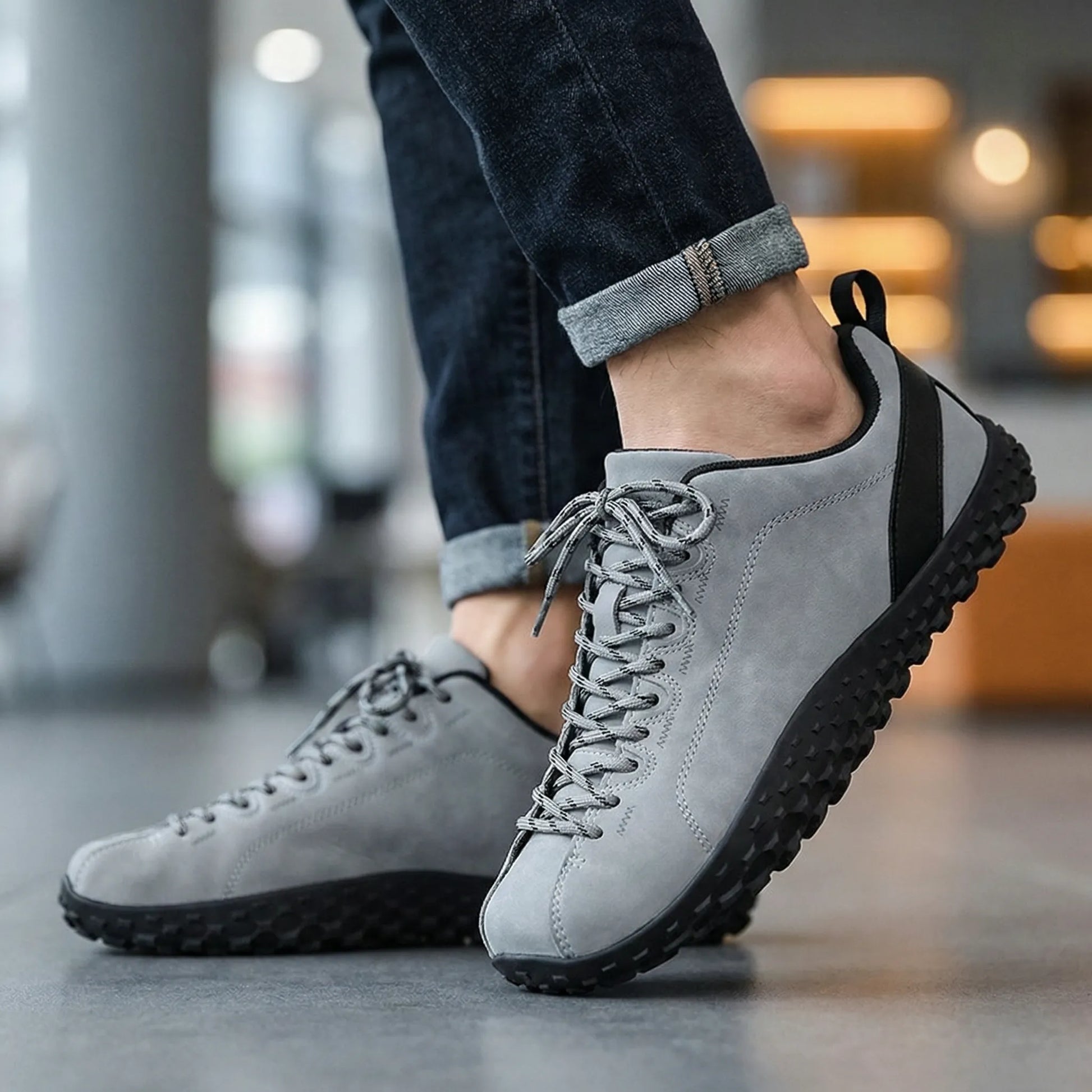 Grey wide toe walking trainers worn while walking indoors