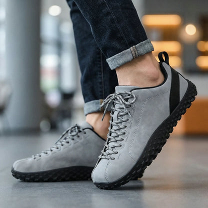 Grey wide toe walking trainers worn while walking indoors