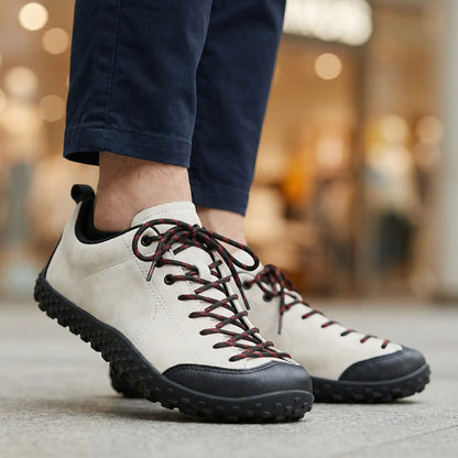 White and black wide toe walking trainers worn in side profile