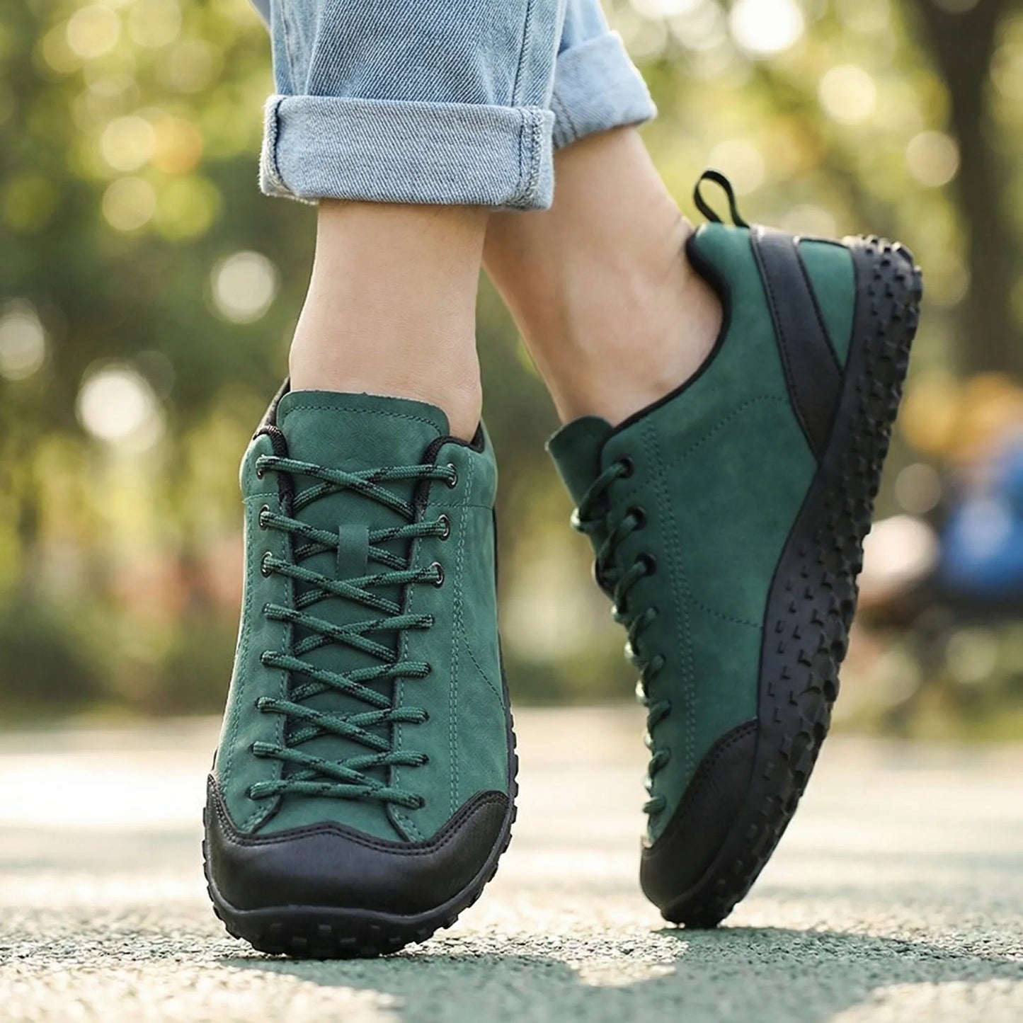 Green wide toe walking trainers worn from the front outdoors