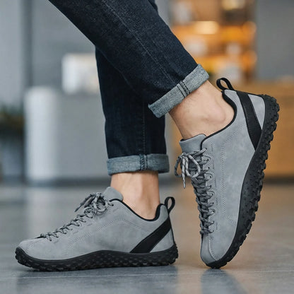 Grey wide toe walking trainers worn in side profile