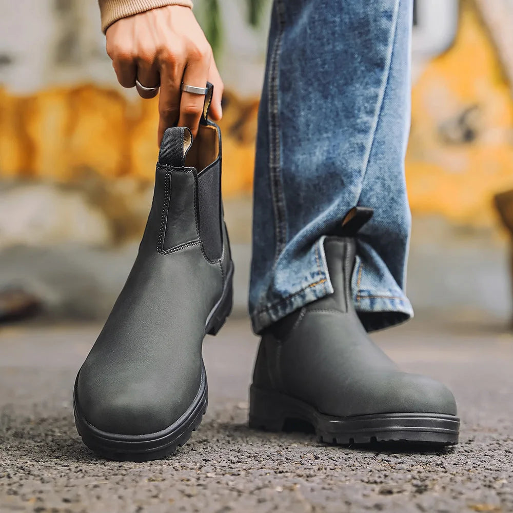 Grey Chelsea boots carried outdoors, side view