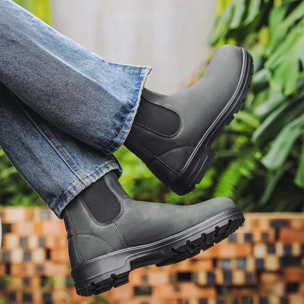 Grey Chelsea boot worn outdoors with lug outsole visible