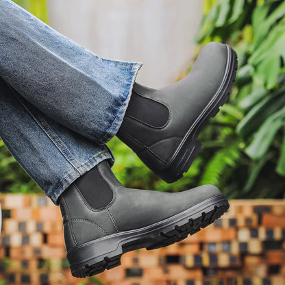 Grey Chelsea boot worn outdoors with lug outsole visible