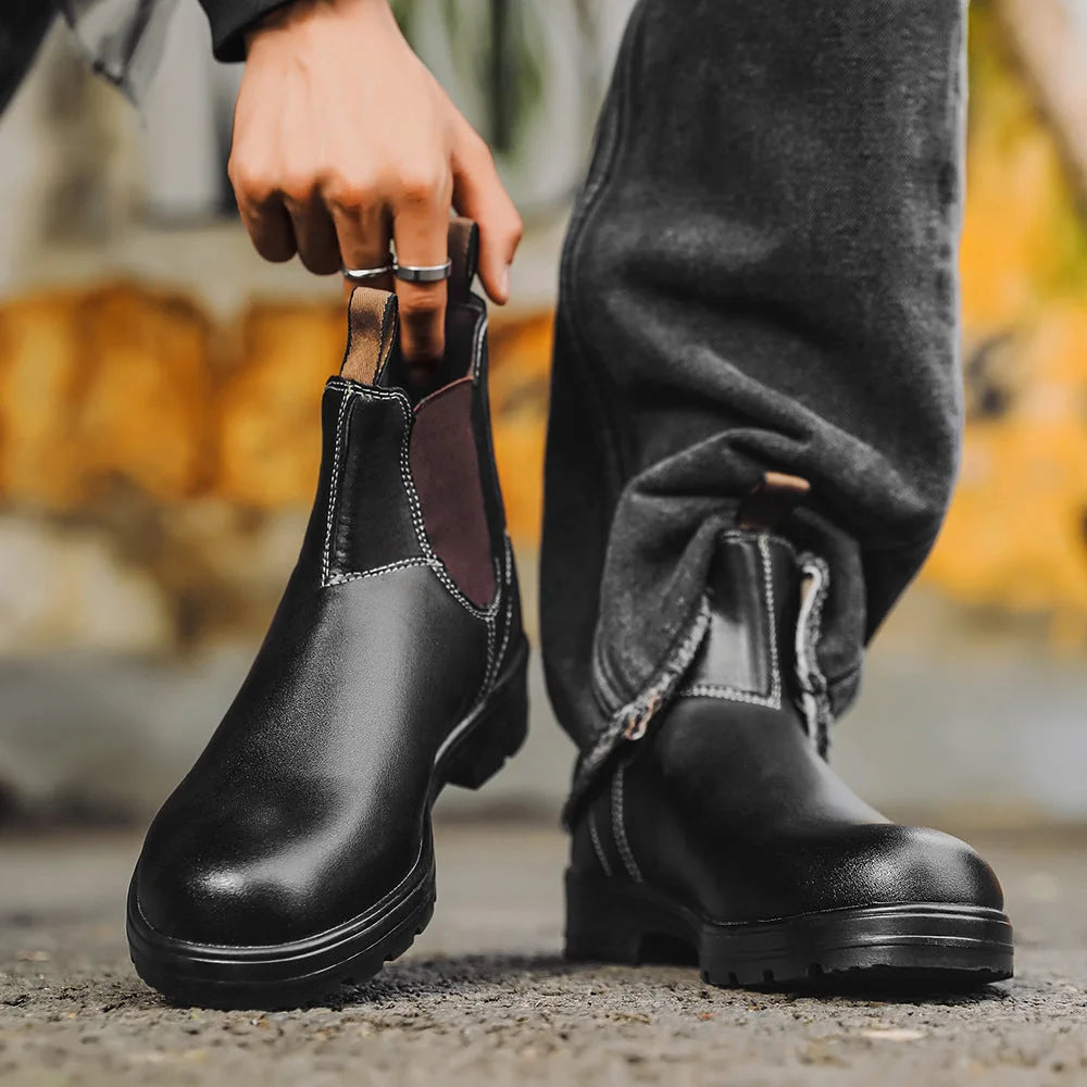 Black Chelsea boots worn with dark trousers, front and side view