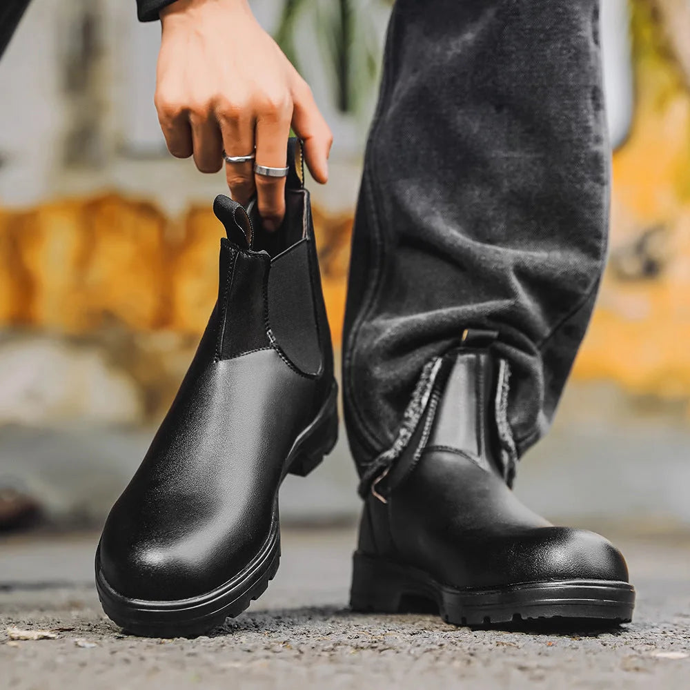 Black Chelsea boots carried outdoors, side view