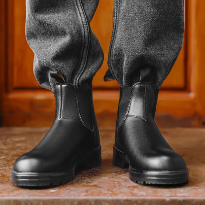 Black Chelsea boots worn with dark trousers, front view