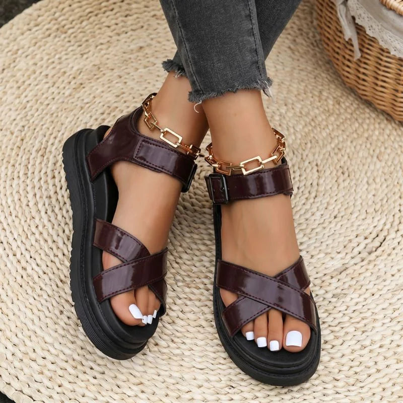 Women's brown cross-strap walking sandals viewed from above on foot