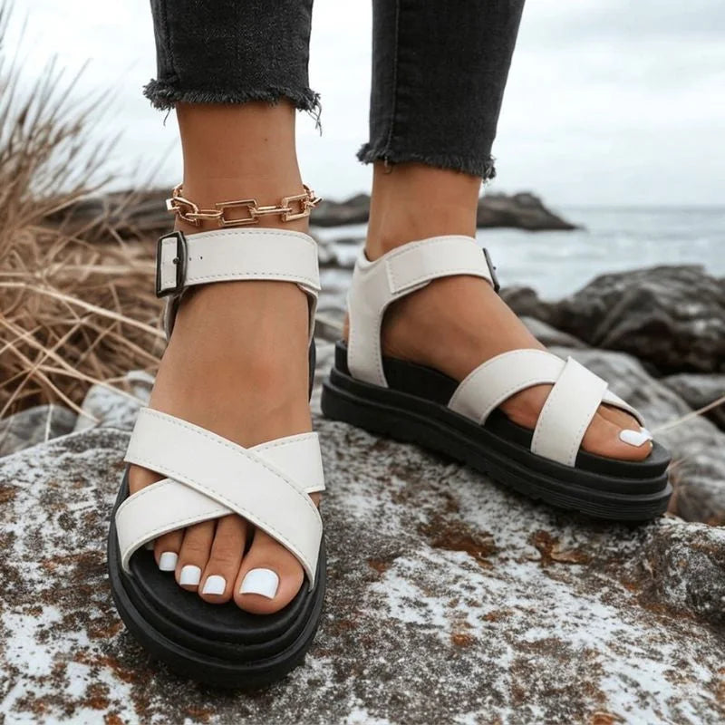 Women's white cross-strap walking sandals worn outdoors