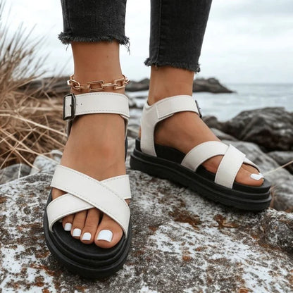 Women's white cross-strap walking sandals worn outdoors