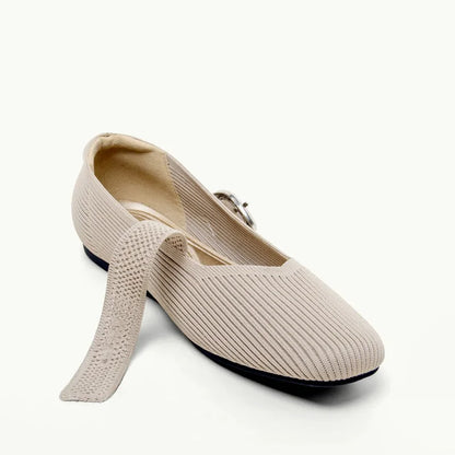 Pair of beige square toe Mary Jane flats with one strap open