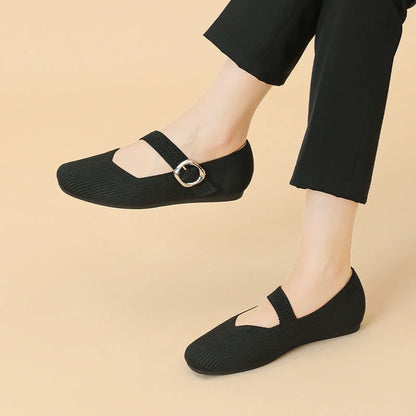 Women's black square toe Mary Jane flats worn in side profile