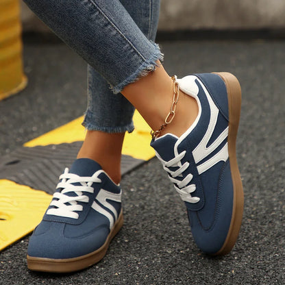 Navy walking trainers for women, angled on-foot view