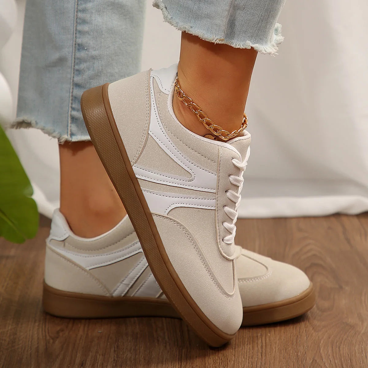 White retro trainers for women, side on-foot view