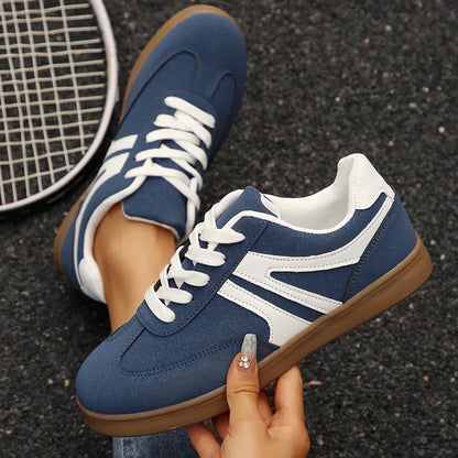 Navy retro trainers for women, top and side hand-held views