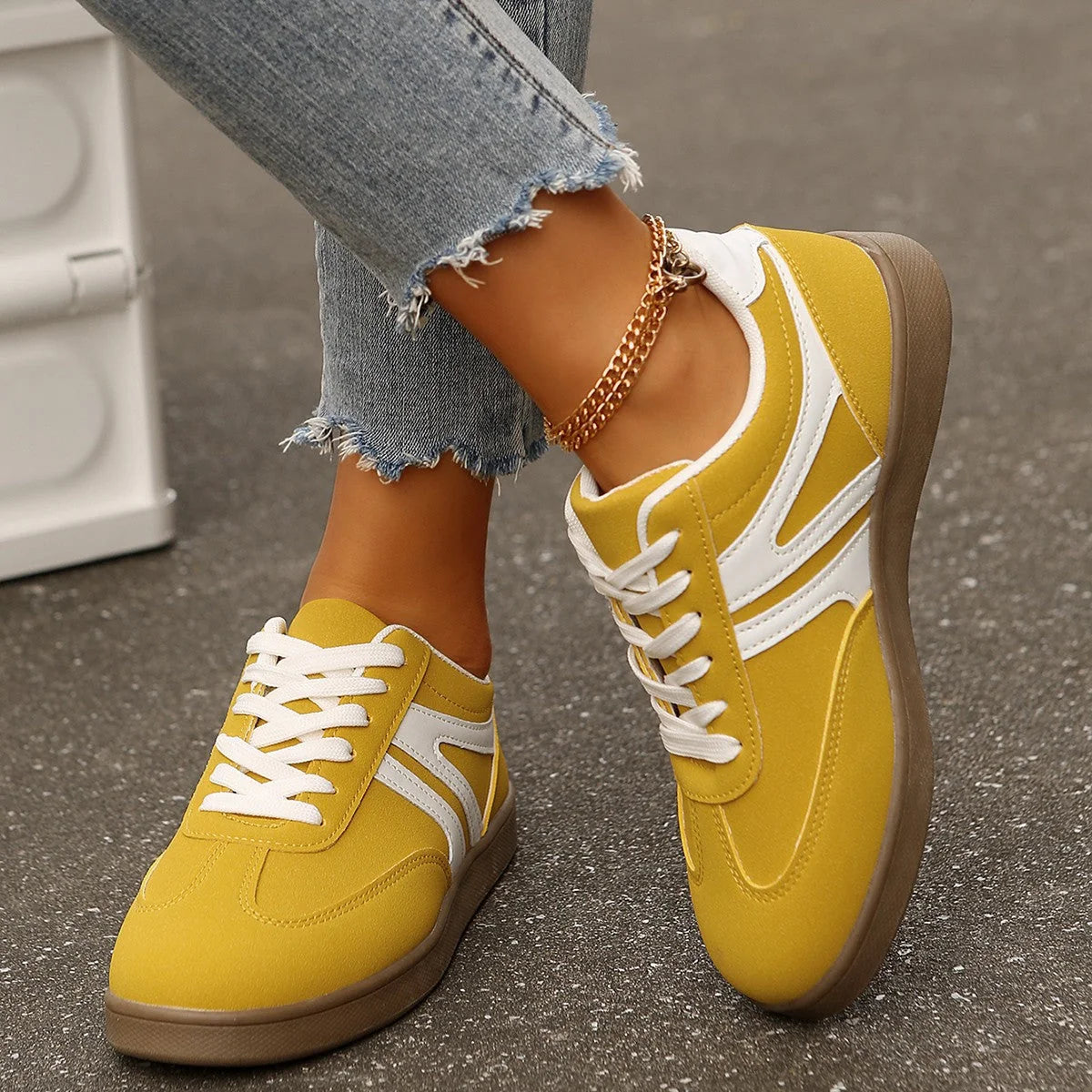 Yellow retro trainers for women, top-down on-foot street view