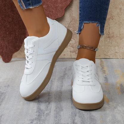 White retro trainers for women, close on-foot view