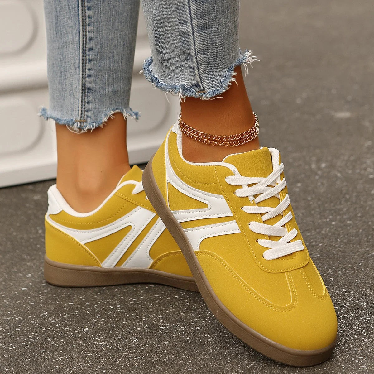 Yellow wide fit trainers for women, angled on-foot view