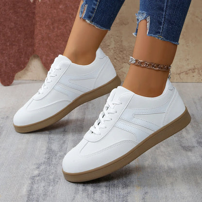 White retro trainers for women, angled on-foot view