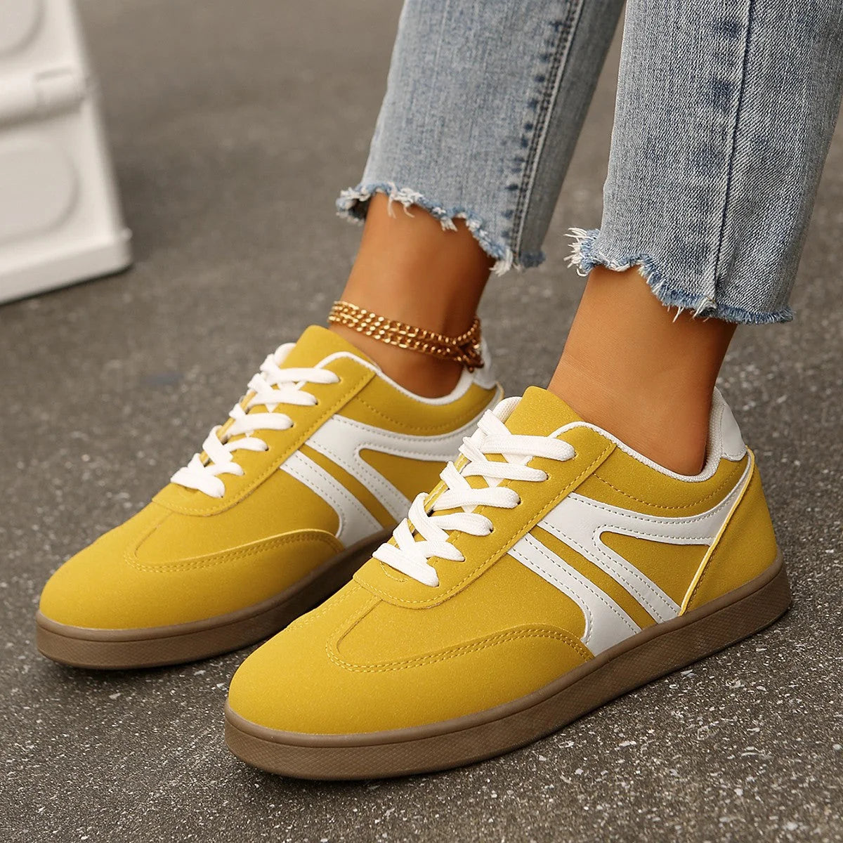 Yellow walking trainers for women, close on-foot street view