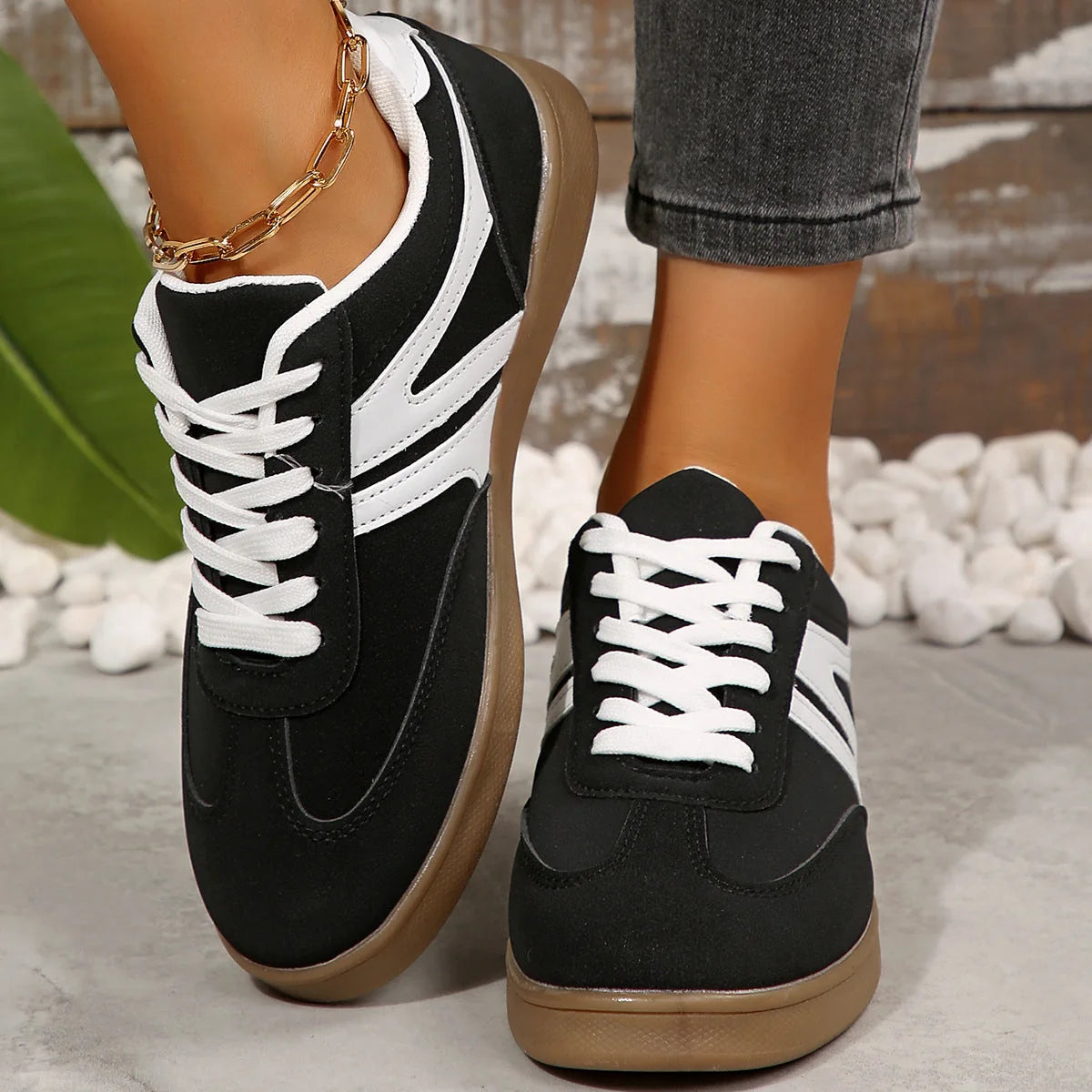 Black walking trainers for women, front on-foot studio view