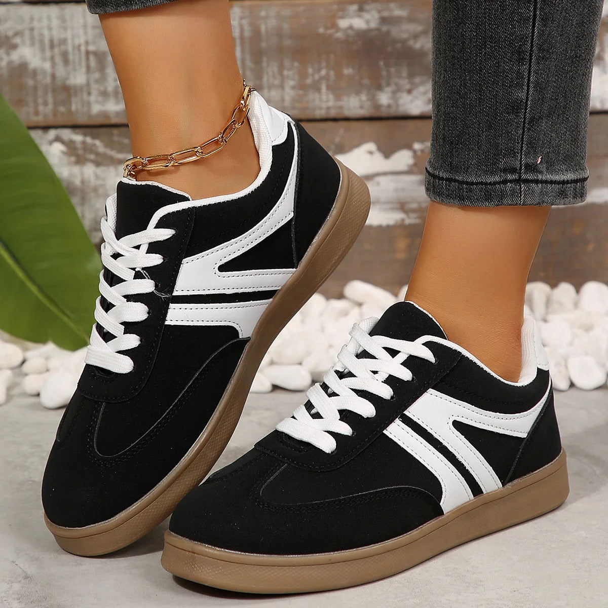Black wide fit trainers for women, side on-foot view