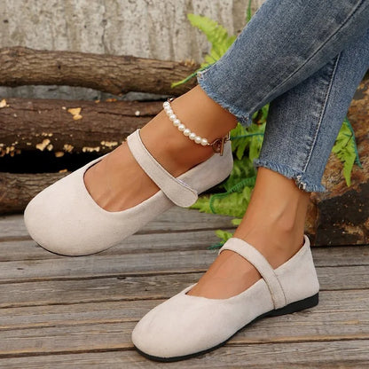 Women's cream Mary Jane flats worn from the side