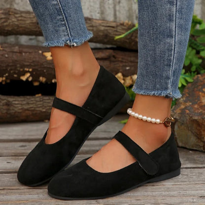 Women's black Mary Jane flats worn in side profile