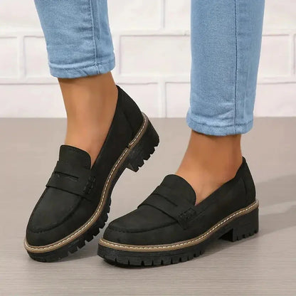 Black platform loafers worn with cropped jeans, front and side view