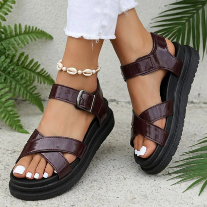 Women's brown cross-strap walking sandals worn from the front