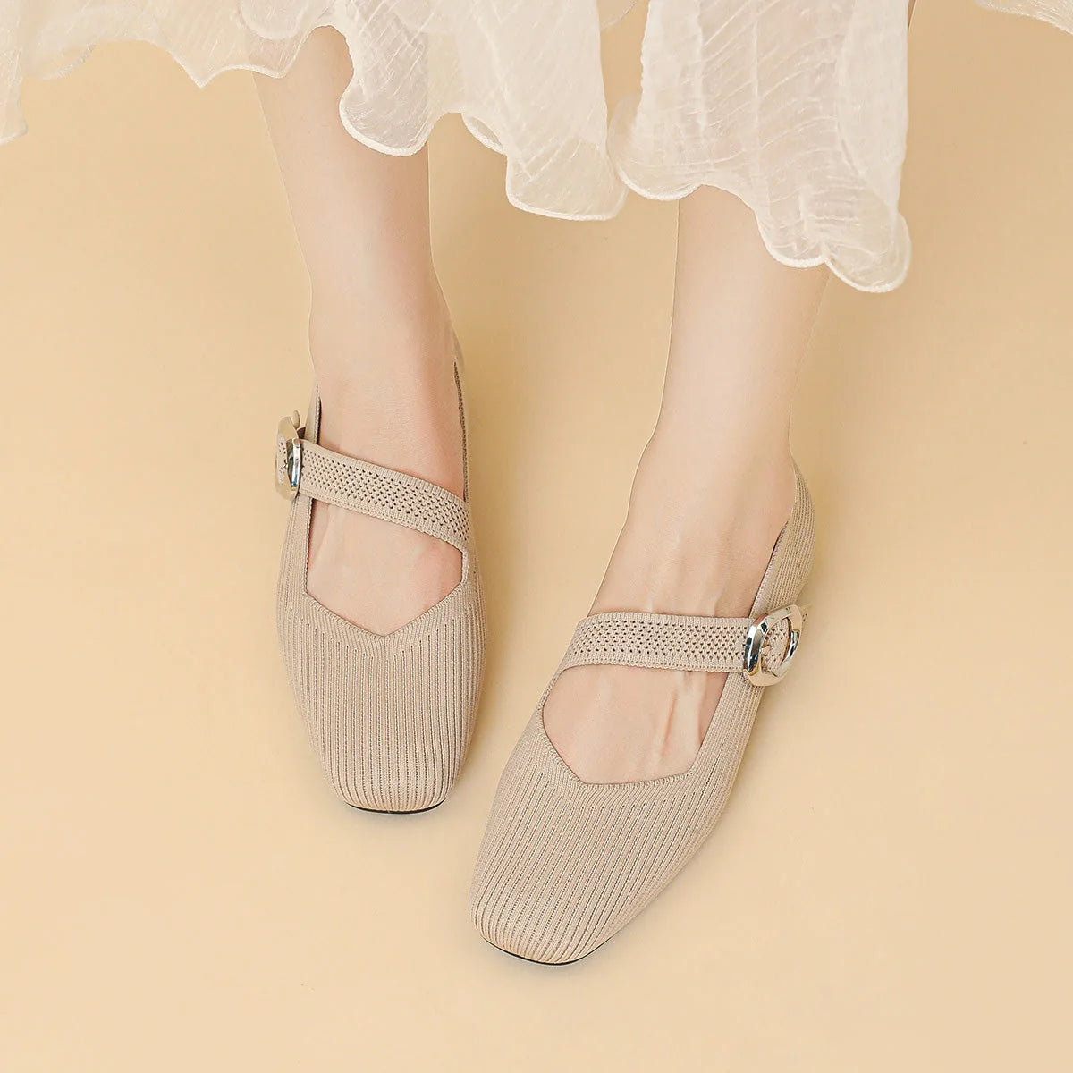Women's beige square toe Mary Jane flats worn from above