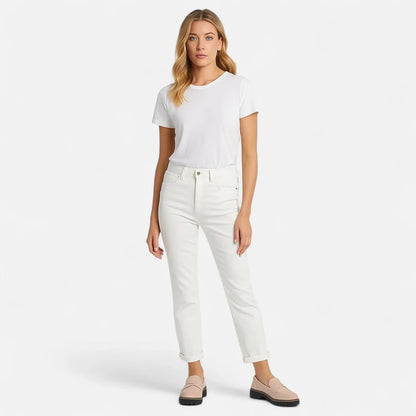 Woman wearing black platform loafers with white trousers, full front view
