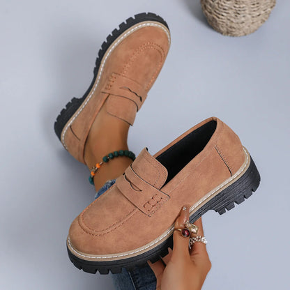 Brown platform loafer shown on foot and held from above