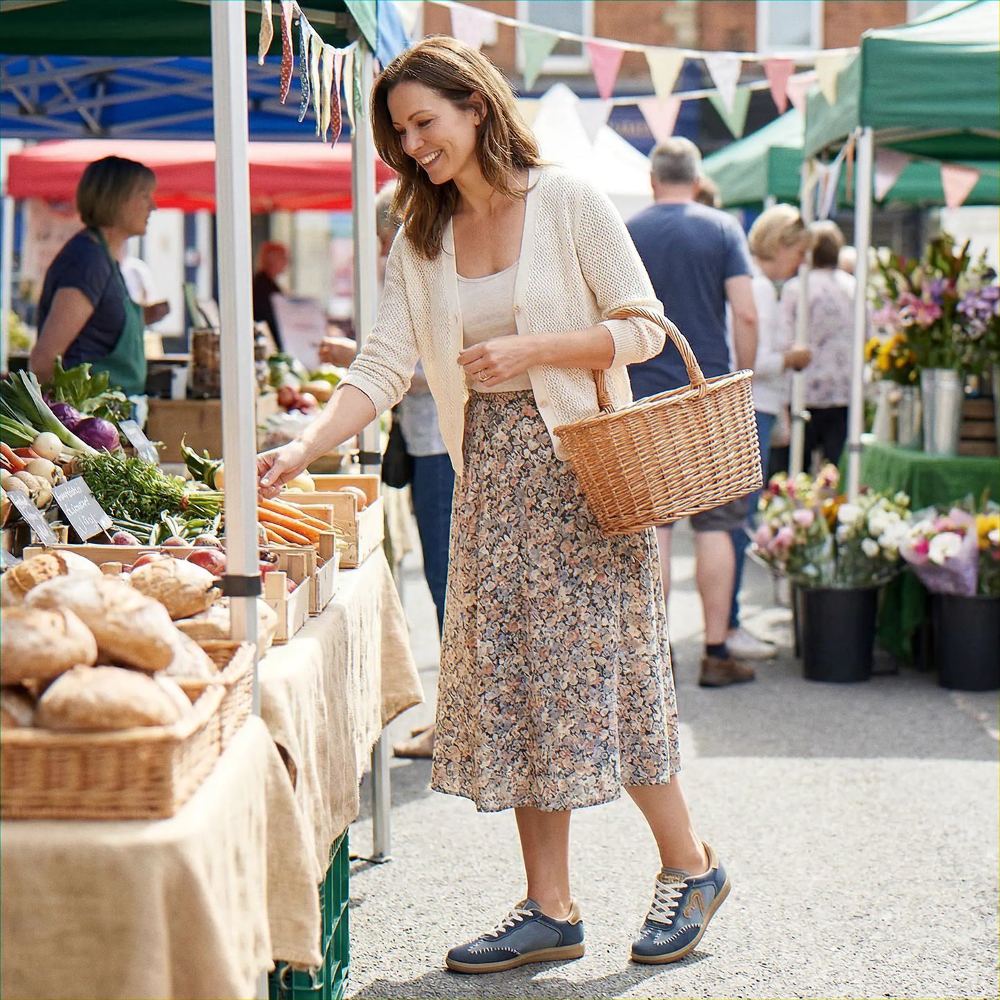 Woman wearing dusty blue trainers at an outdoor market