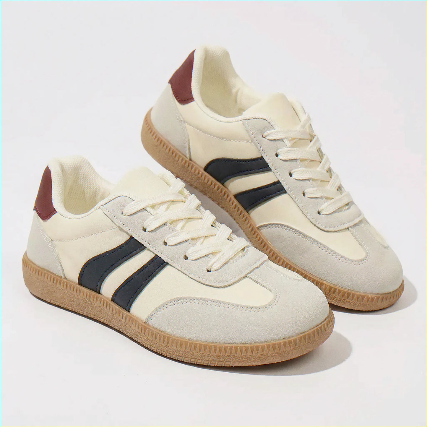 Cream and navy retro trainers, side and angled studio views