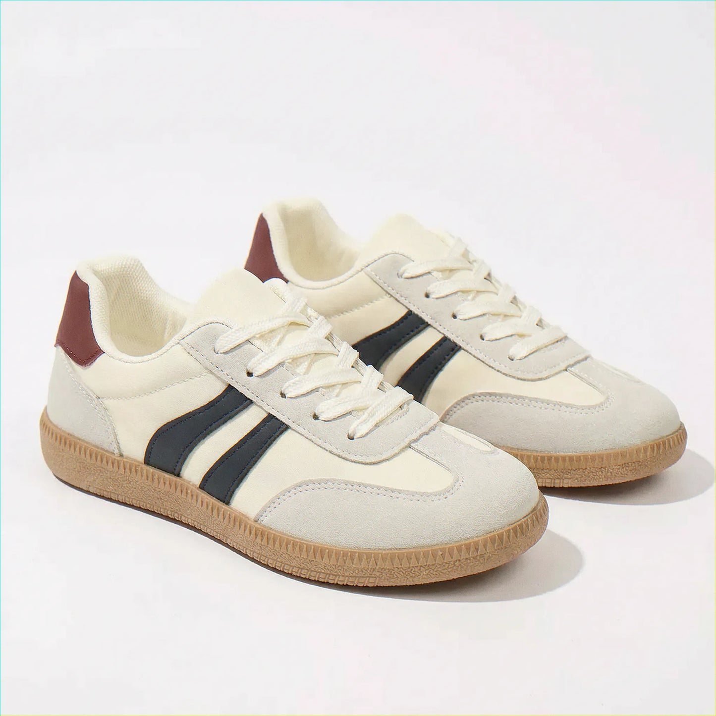 Cream and navy trainers for women, angled studio pair