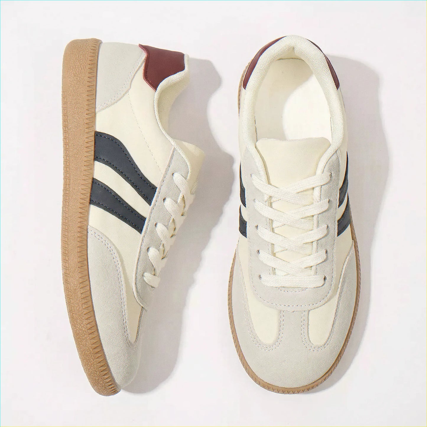 Cream and navy retro trainers for women, angled studio pair