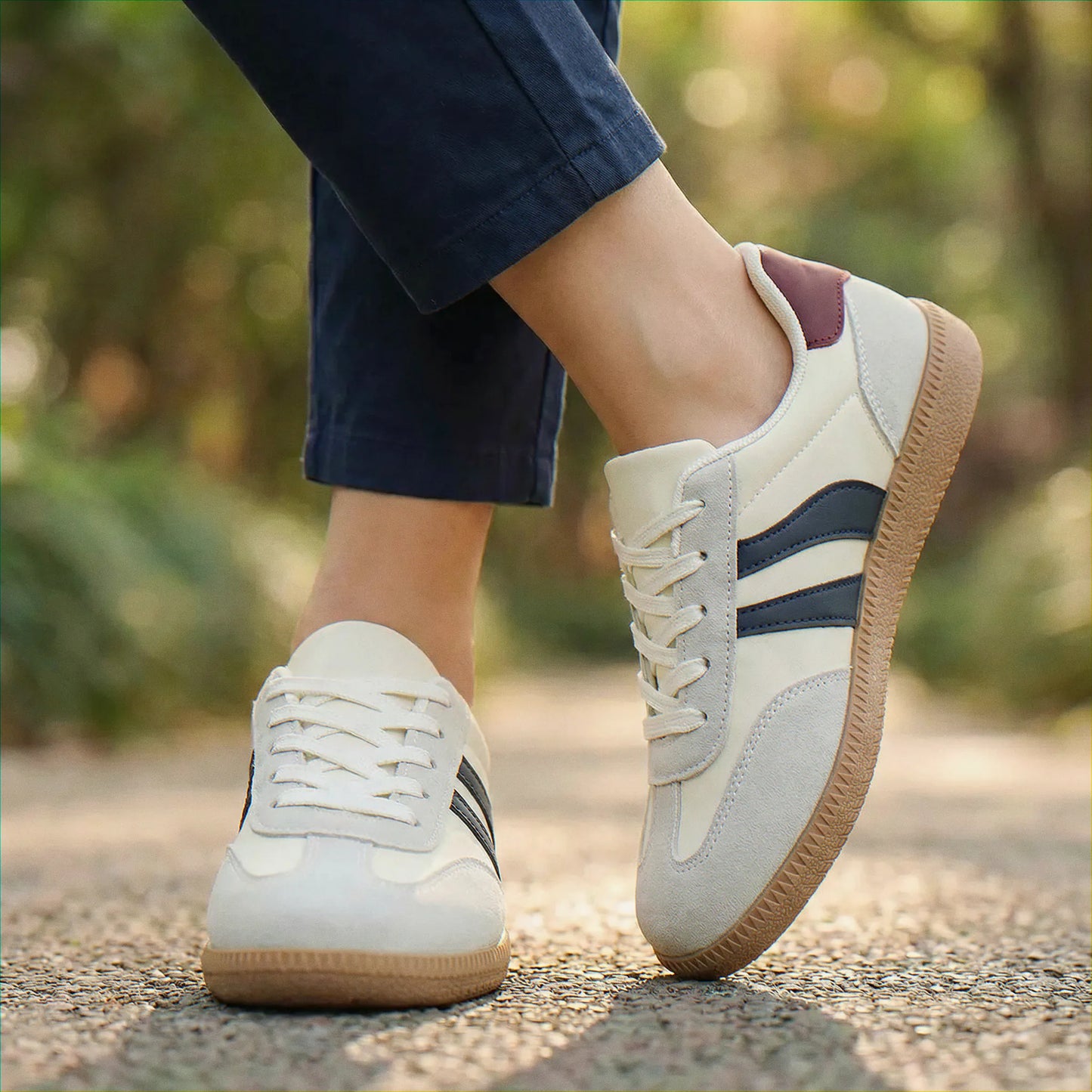 Cream and navy walking trainers, close on-foot outdoor view