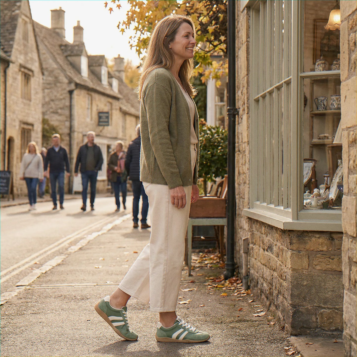 Woman wearing olive green trainers on a village street