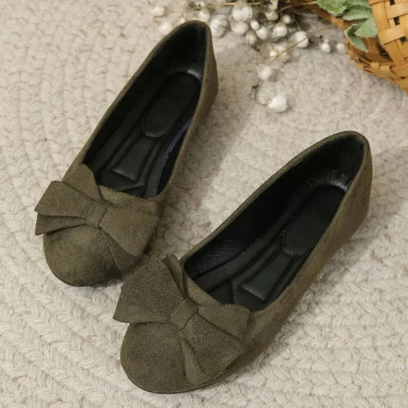 Pair of women's olive bow ballet flats viewed from above